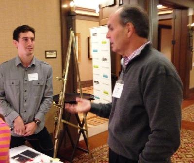 CEI student Dane DeQuilletes talks with Puget Sound Energy executive Phil Bussey 