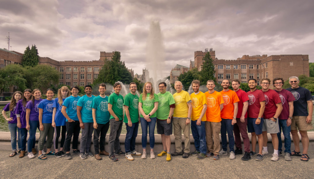 People in colorful shirts in front of a fountain