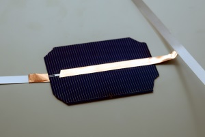 Conductive copper tape connects the front of one cell to back of another. Conductive copper tape connects the front of one cell to back of another.