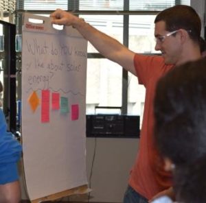 Graduate students from UW and high school students from TAF Academy discuss the benefits of solar energy.