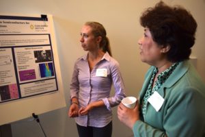 UW Clean Energy Institute graduate fellow Genevieve Clark discusses her research at a lunchtime poster session.