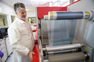 Devin Mackenzie and the roll-to-roll printer at the Testbeds