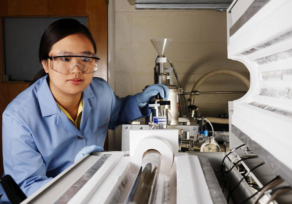 Researcher looking at a piece of lab equipment