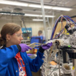 Joelle Scott loading a sample into a lab reactor